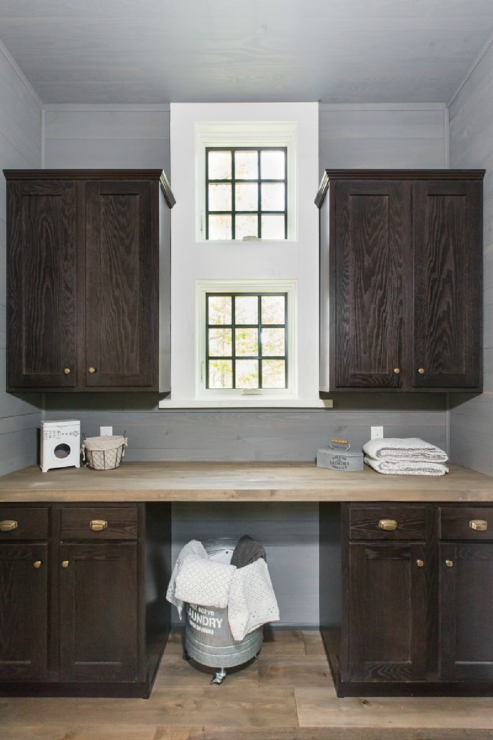 Laundry area with counter in Jeffrey Dungan designed tiny house with finely crafted Low Country style -one of the cottages at The Retreat at Oakstone in Tennessee. #tinyhousedesign