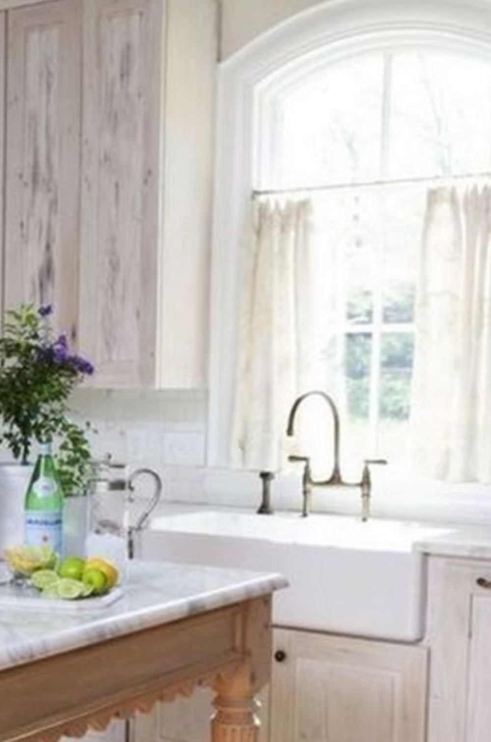 Beautiful Frnech country kitchen with rustic aged cabinets and farm sink - via CuratedInterior. #europeancountrykitchen #farmsinks