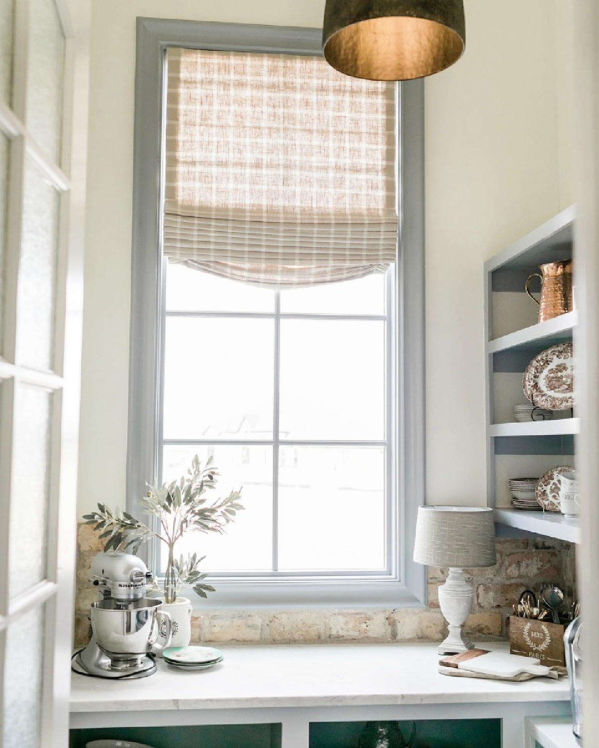 SW Alabaster in a lovely country French pantry with window and built-in shelves - Brit Jones Design.