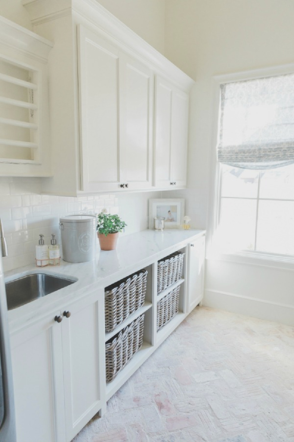 Beautiful romantic country French laundry room with SW Alabaster walls and Chicago brick herringbone flooring - Brit Jones Design.