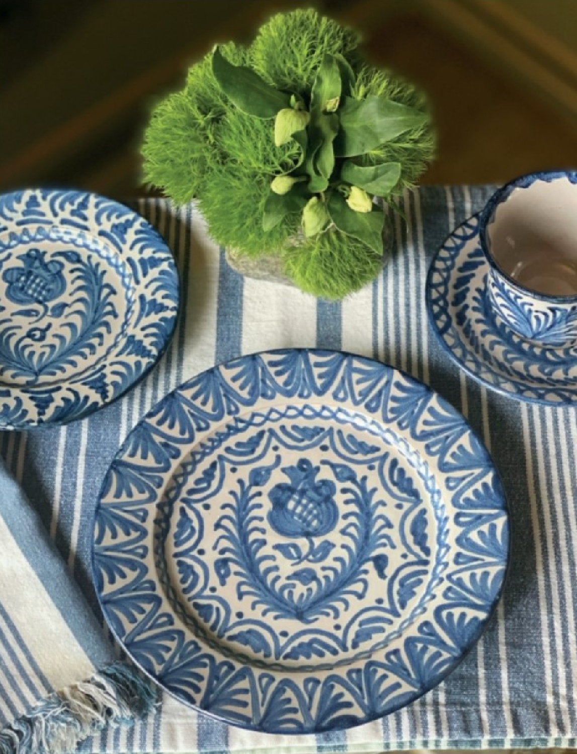 Sophisticated and beautiful tablescape by Stephanie Stokes in THE WORLD AT YOUR TABLE with Judith Nasatir (Rizzoli, 2023). #tablescape #tabletopinspiration #diningroomgoals