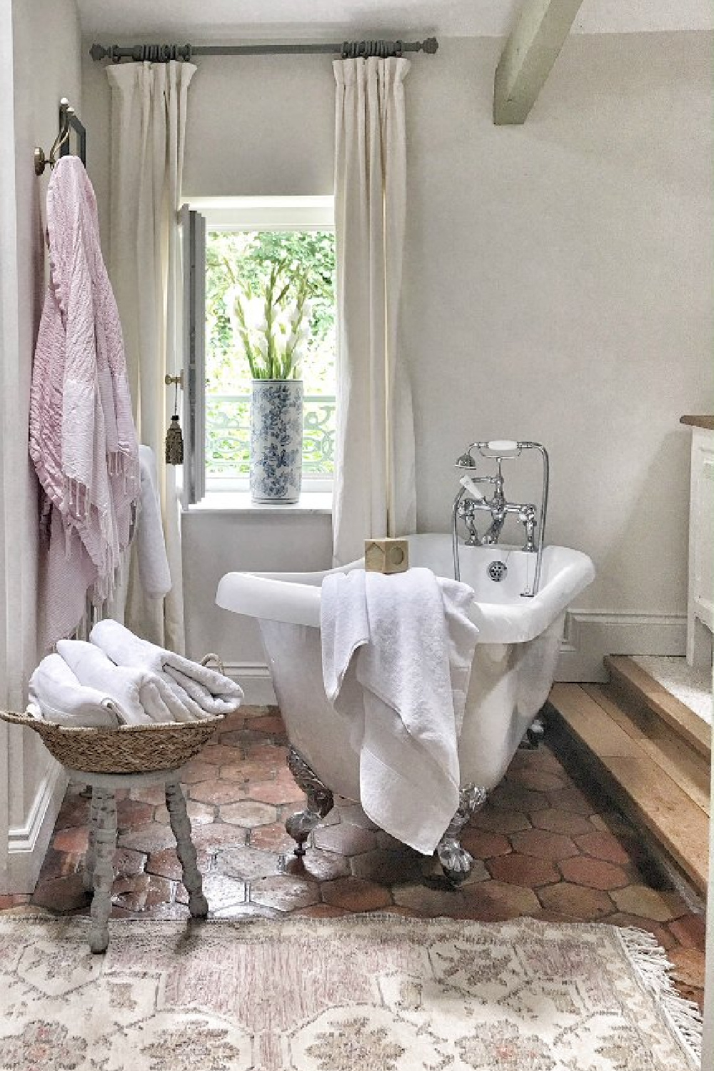 Farrow & Ball Strong White in a French farmhouse bathroom with clawfoot tub and reclaimed terracotta hex tile floor - Vivi et Margot.