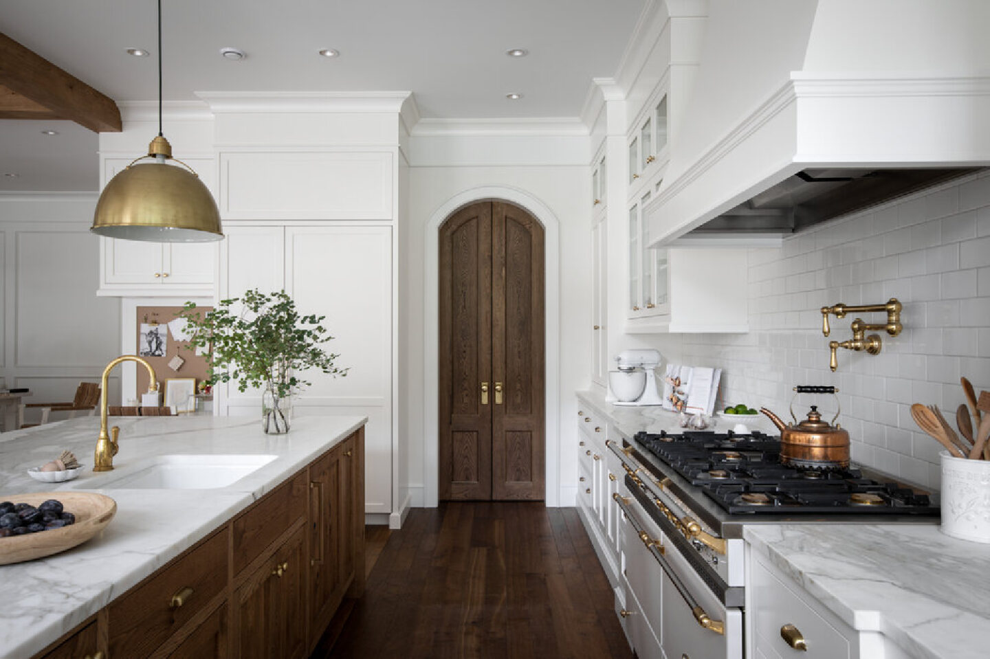 Arched door in beautiful French country home with interior design by Jenny Martin Design. #frenchcountrykitchen #interiordesign