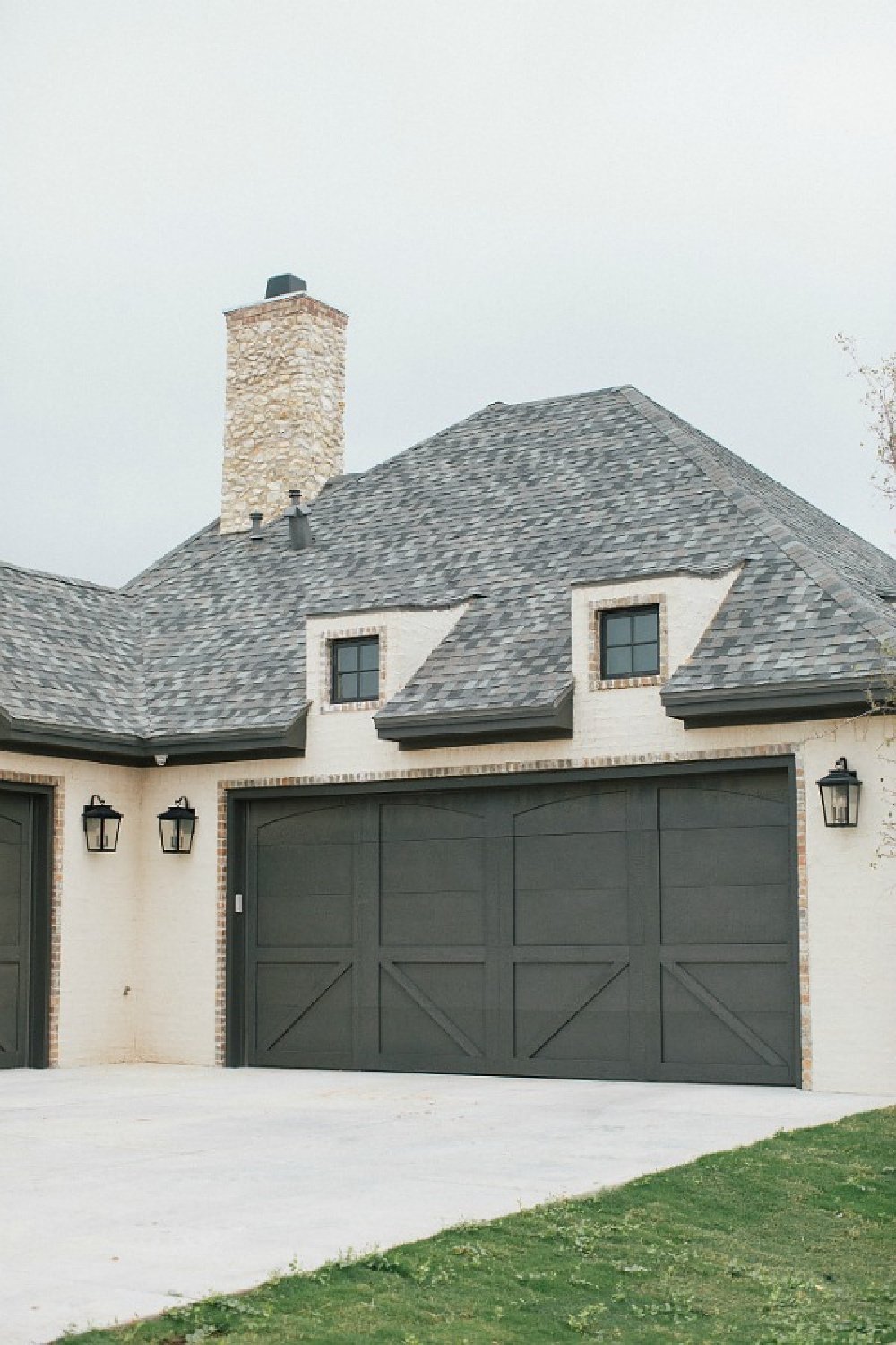 Sealskin paint color on garage. Stucco, brick, stone, and country French architecture for a new home in Texas - Brit Jones Design.