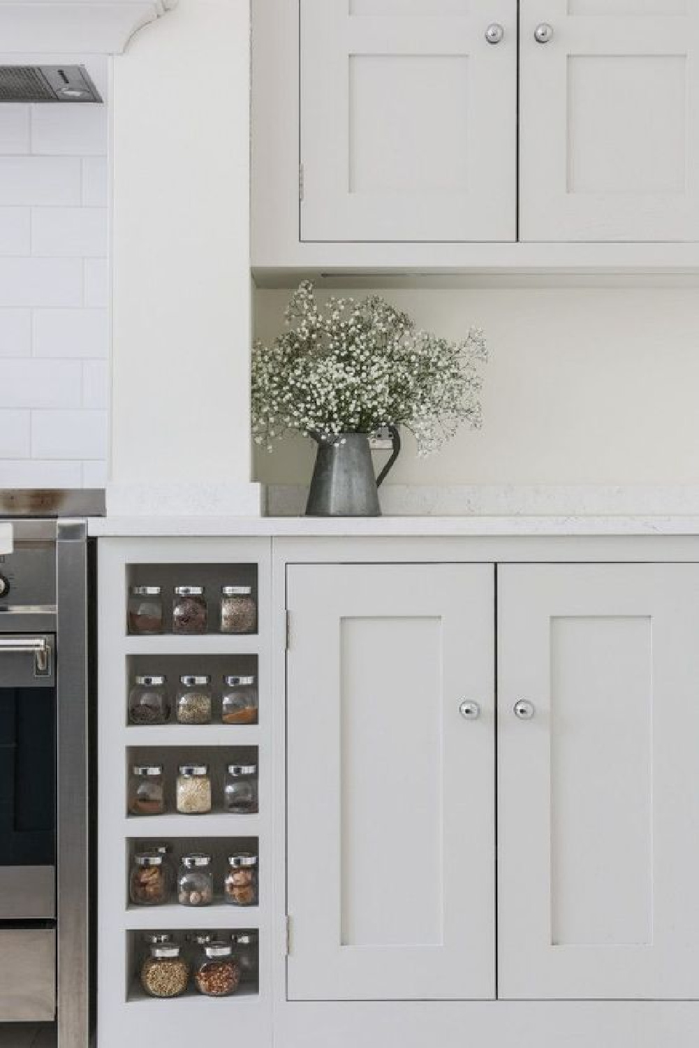 Sustainable Kitchens - Bright Open Plan Family Kitchen in London. Oak shaker style cabinetry painted in Farrow & Ball Ammonite with built in spice racks on both sides of the Smeg range cooker. The worktop is Bianco Fantasia. Come explore Interior Designers Favorite White Paint Colors for ideas, photos, and inspiration.