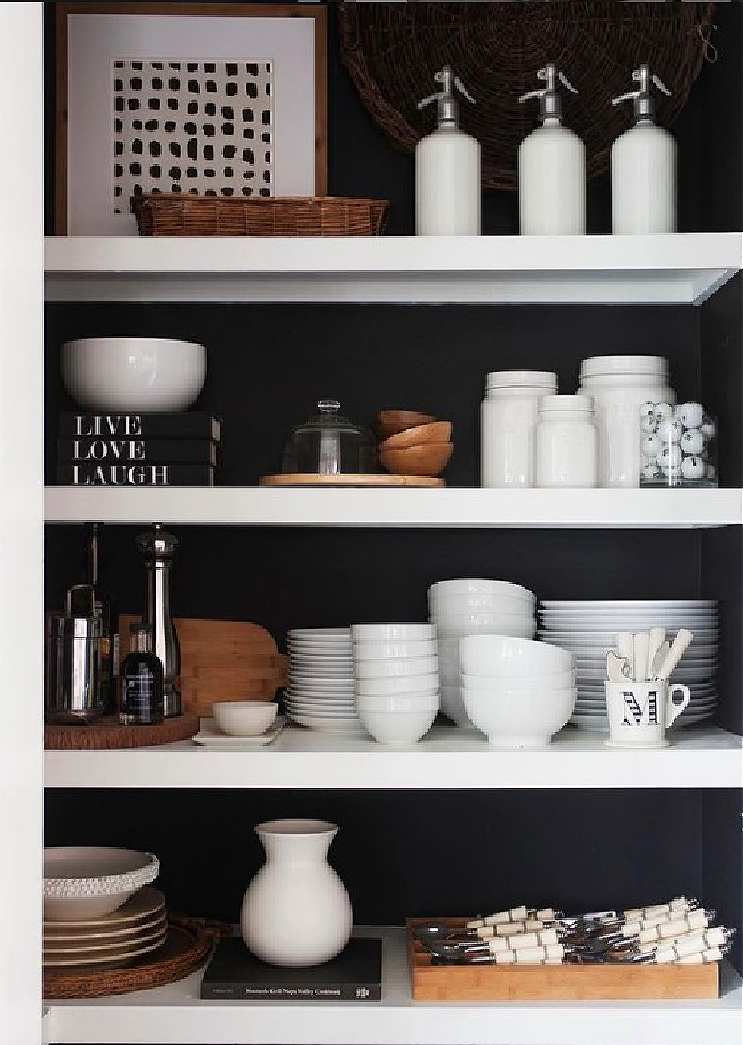 Deep black painted pantry wall with white shelves and white dishes - Sherry Hart. #blackwalls #blackpaintcolors #blackandwhiteinteriors