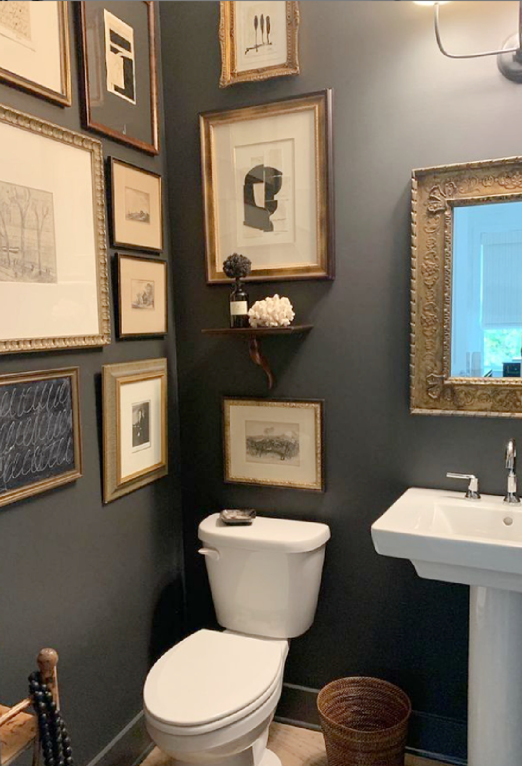 Benjamin Moore Wrought Iron black paint color on gallery wall in powder room designed by Sherry Hart - @sherryhdesigns. #blackpaintcolors #bmwroughtiron #gallerywalls