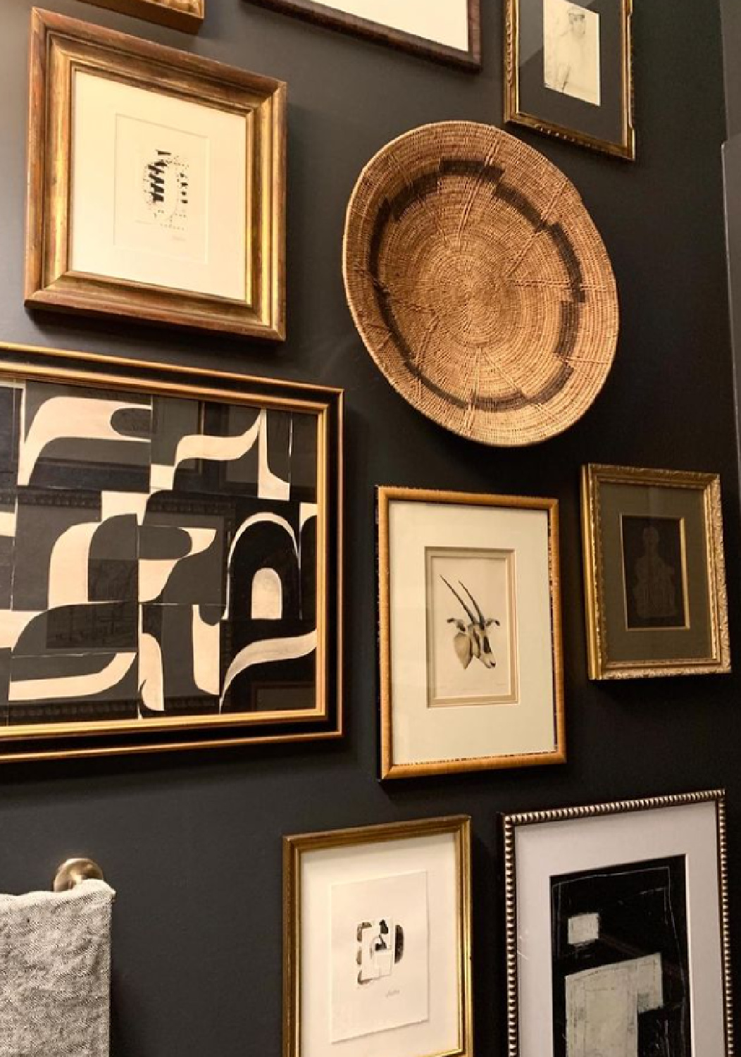 Benjamin Moore Wrought Iron black paint color on gallery wall in powder room designed by Sherry Hart - @sherryhdesigns. #blackpaintcolors #bmwroughtiron #gallerywalls