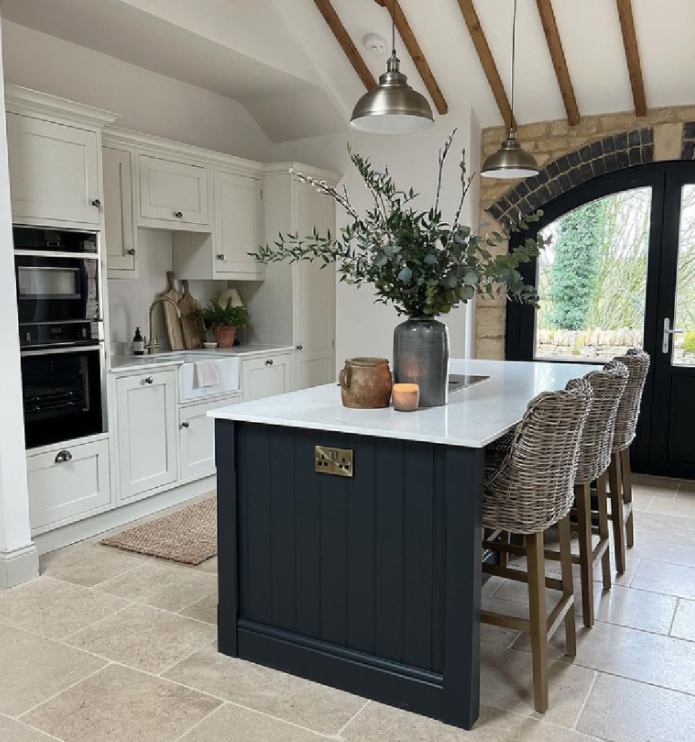 Beautiful black and white rustic modern Cotswolds kitchen by Torn and Cotton Interiors with black island. #farrowandballrailings #blackpaintcolors