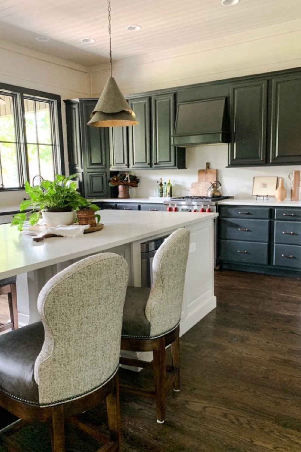 Black Fox (Sherwin-Williams) paint color on black kitchen cabinets in a home with design by Sherry Hart - @sherryhdesigns. #blackfox #blackpaintcolors