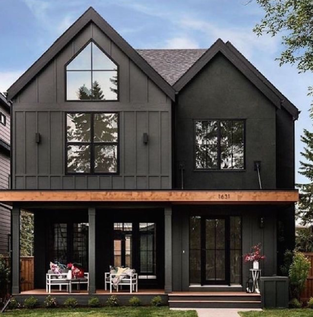 Beautiful dramatic soft black or dark charcoal board and batten house exterior - @tricklecreekyyc. Try BM Iron Mountain for a similar look. #blackhouseexteriors