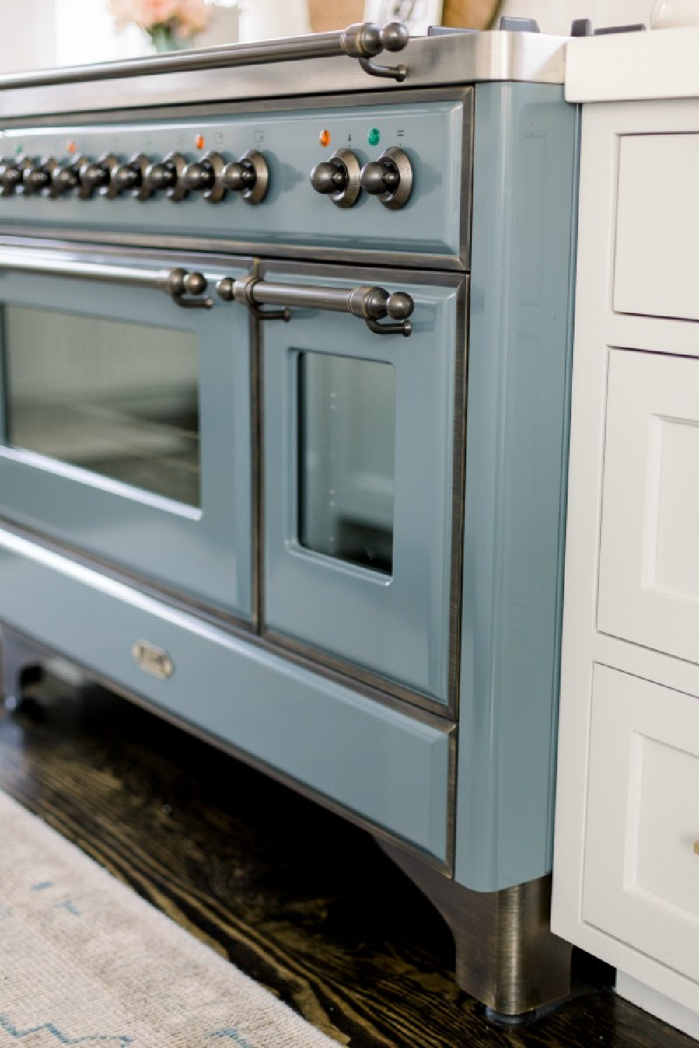 Elegant white farmhouse kitchen with Benjamin Moore Repose Grey cabinets, subway tile, gold accents, and reclaimed barn wood. Design: Finding Lovely. Wall color: Benjamin Moore Chantilly Lace.