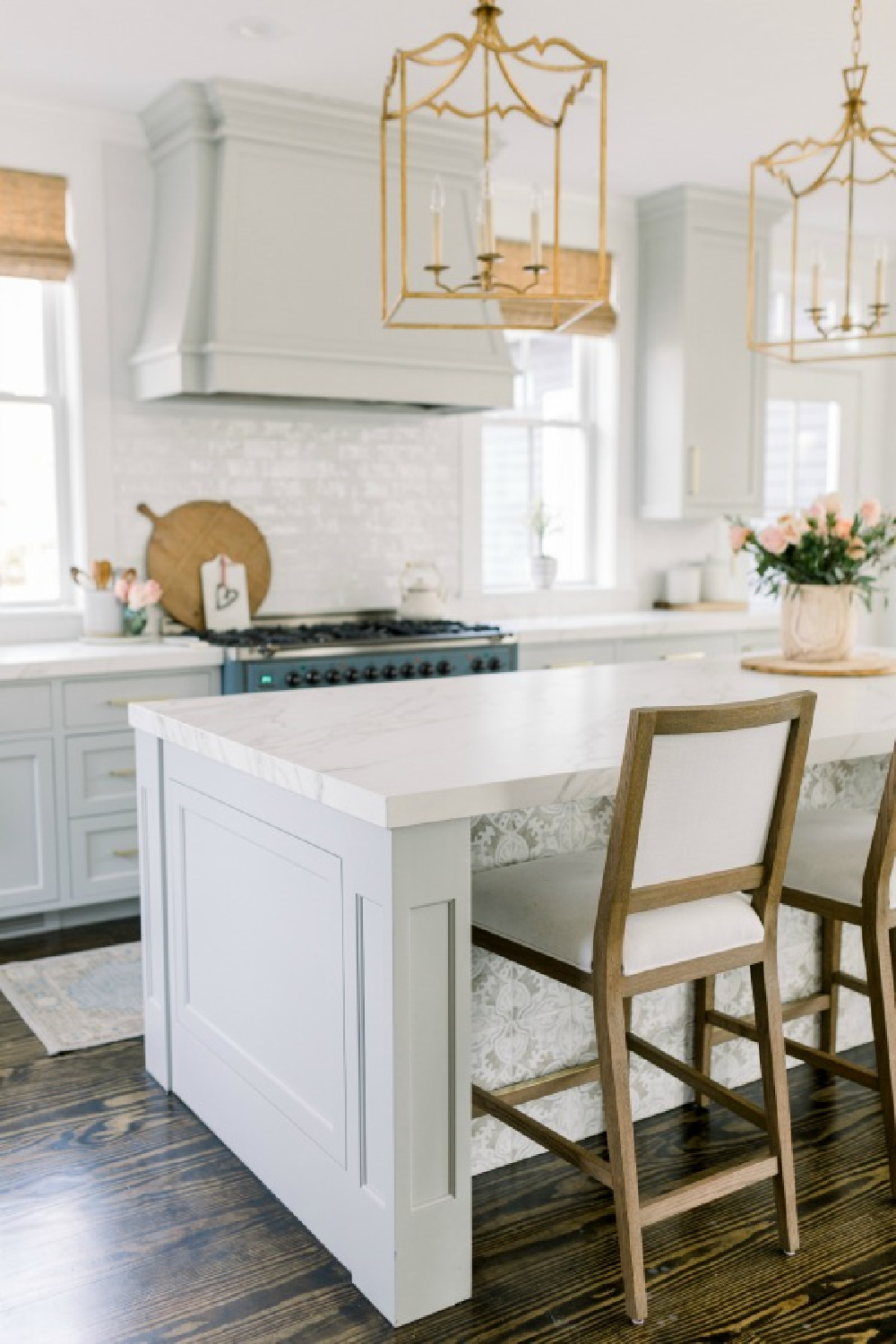 Elegant white farmhouse kitchen with Benjamin Moore Repose Grey cabinets, subway tile, gold accents, and reclaimed barn wood. Design: Finding Lovely. Wall color: Benjamin Moore Chantilly Lace.