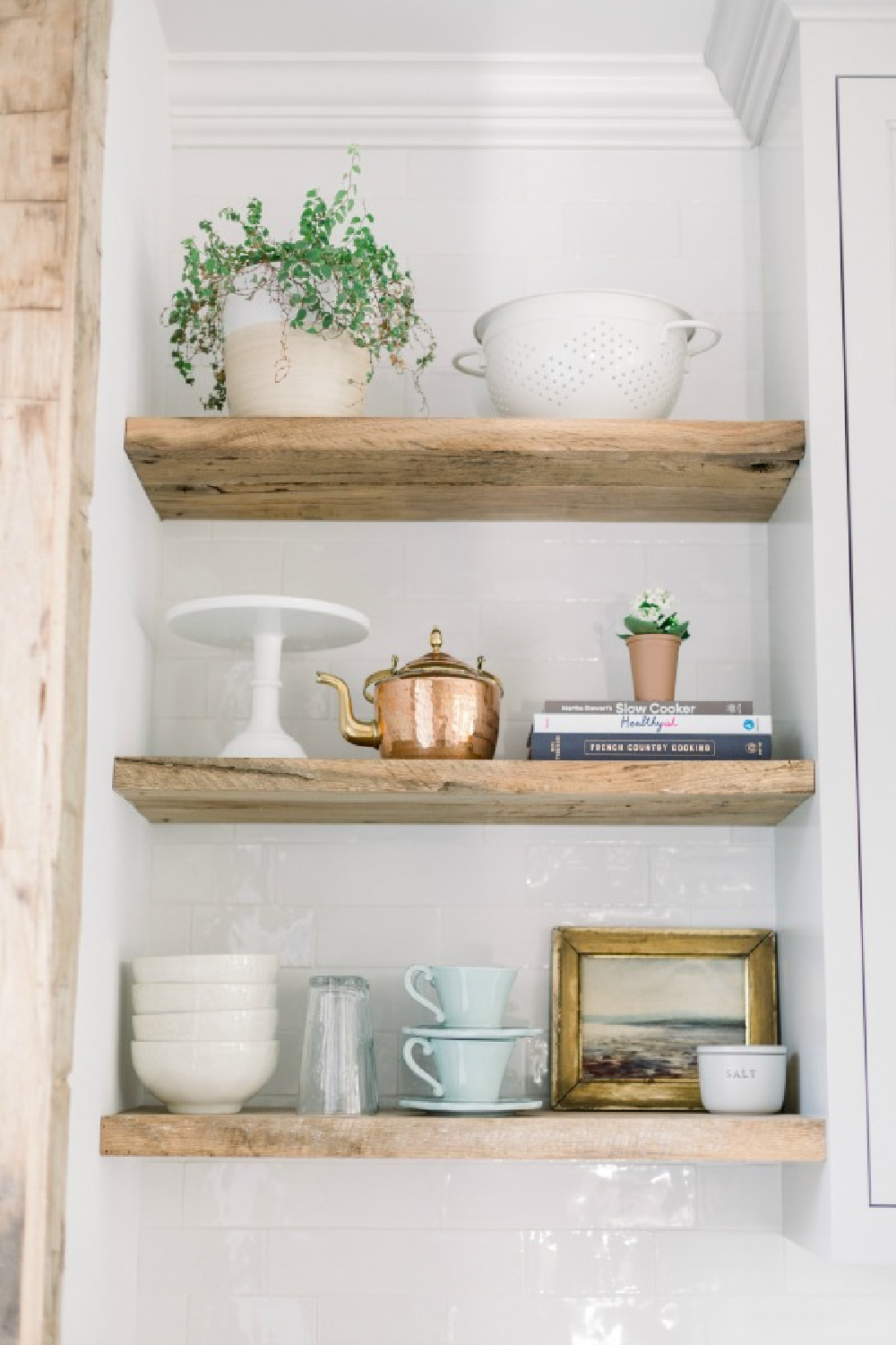 Elegant white farmhouse kitchen with Benjamin Moore Repose Grey cabinets, subway tile, gold accents, and reclaimed barn wood. Design: Finding Lovely. Wall color: Benjamin Moore Chantilly Lace.