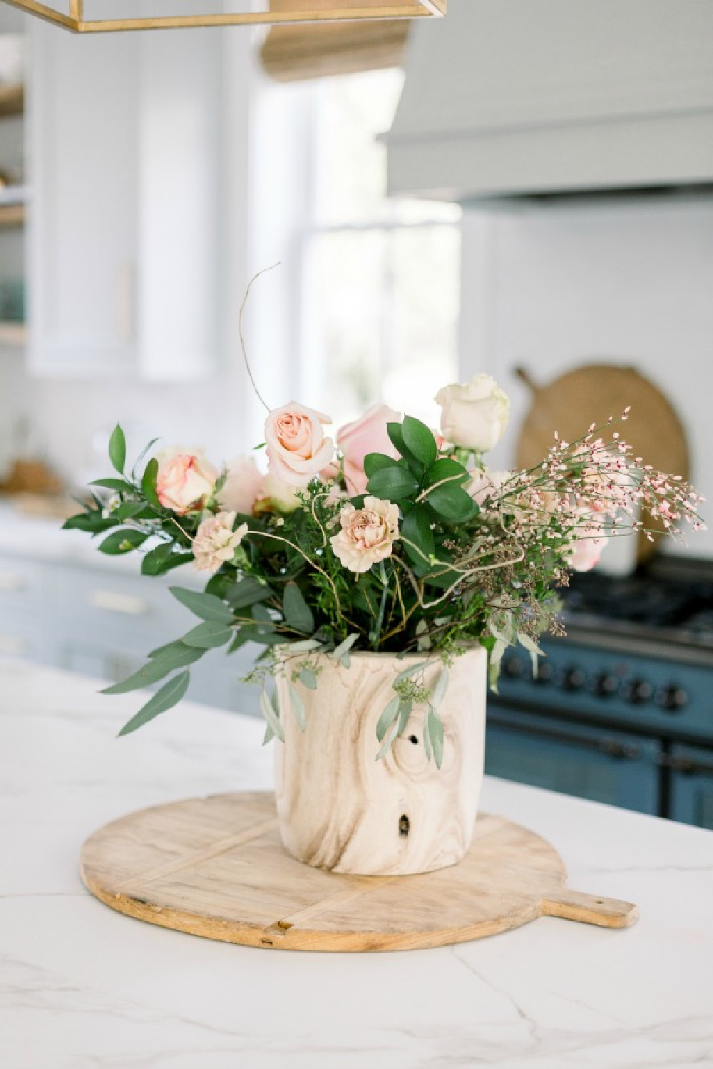 Elegant white farmhouse kitchen with Benjamin Moore Repose Grey cabinets, subway tile, gold accents, and reclaimed barn wood. Design: Finding Lovely. Wall color: Benjamin Moore Chantilly Lace.