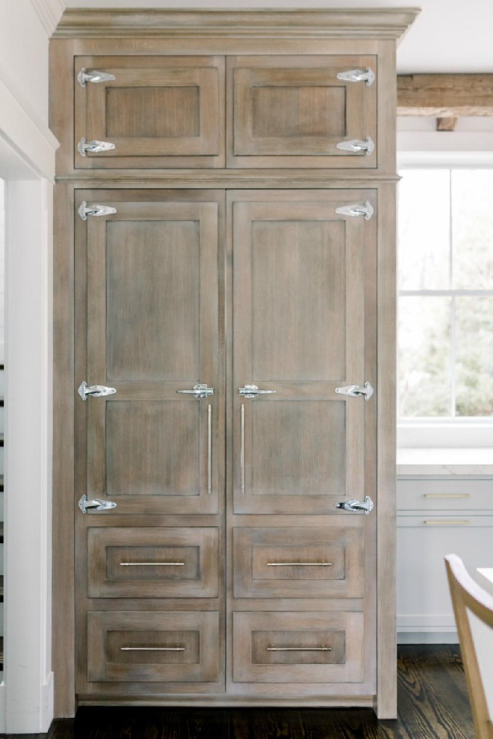 Custom paneled icebox in an elegant white farmhouse kitchen with Benjamin Moore Repose Grey cabinets: Finding Lovely. Wall color: Benjamin Moore Chantilly Lace.
