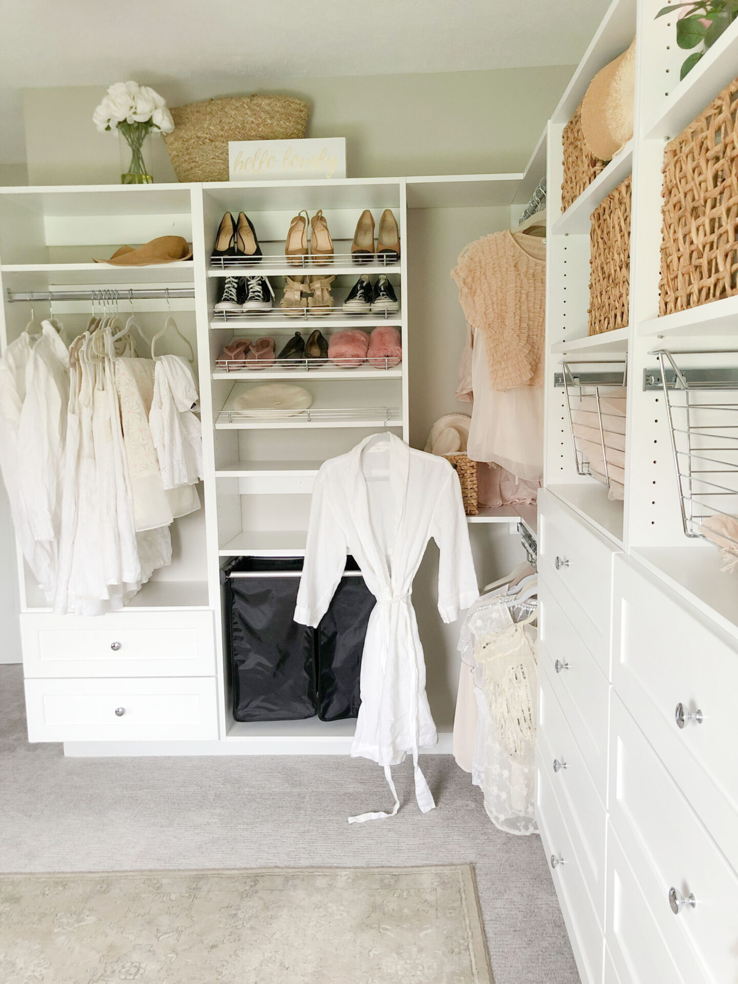 Slanted shoe shelves, hamper pull out drawer, and chrome pull out bins make this DIY custom closet system perfect for my needs - Hello Lovely Studio. #closetupgrade #diycloset #closetaccessories