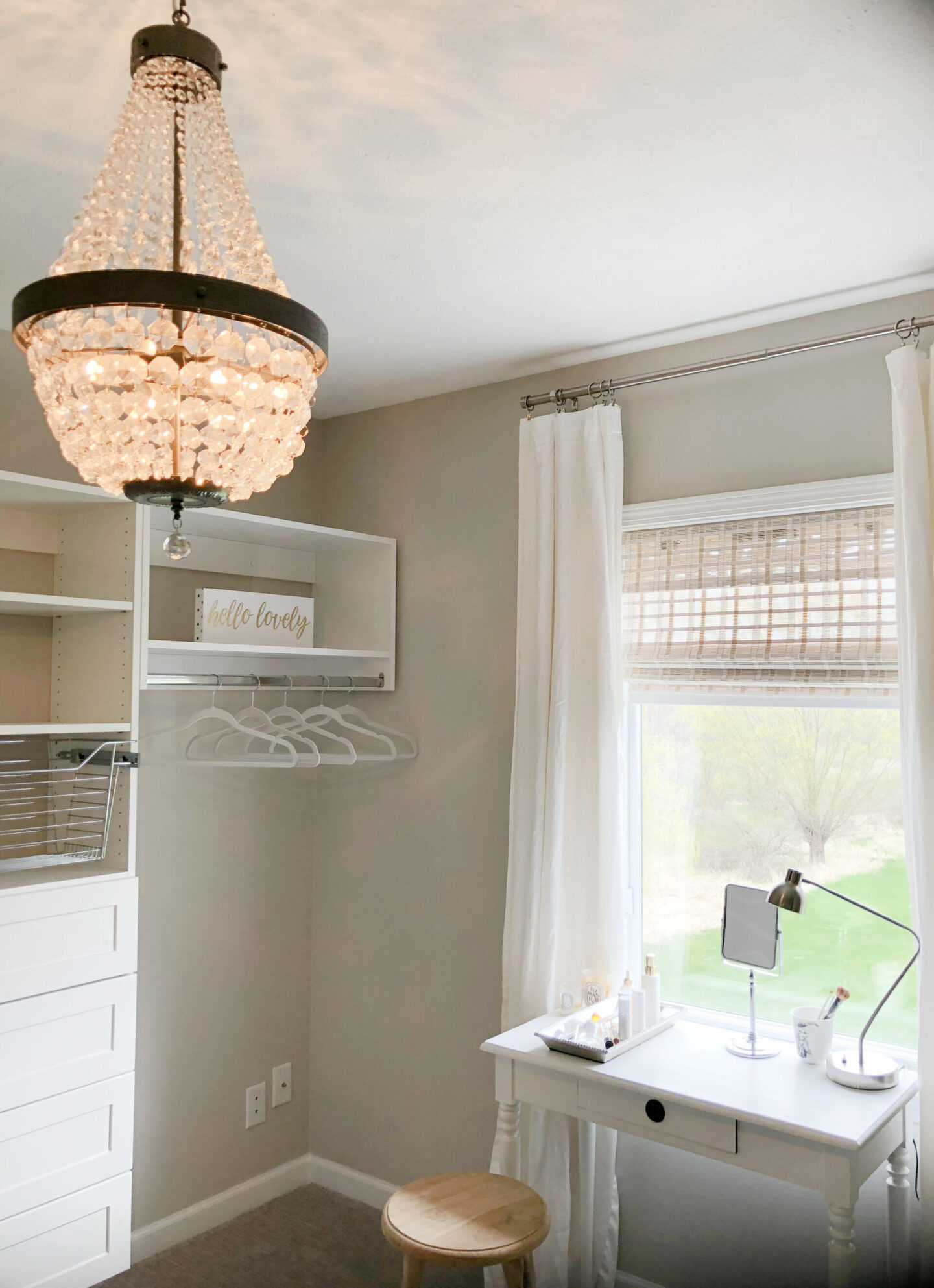 Crystal chandelier, closet system from Modular Closets, and a vintage desk transformed an awkward little bedroom into an inviting closet, home office, and dressing area - Hello Lovely Studio. #cloffice #homeoffices #diycloset