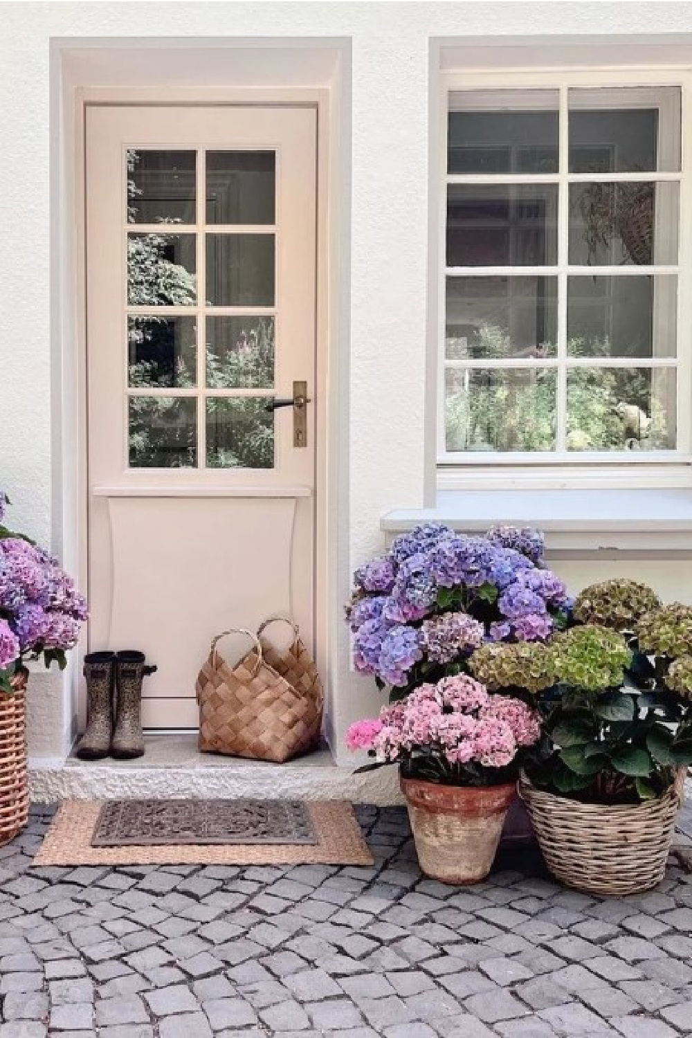 Farrow & Ball Pink Ground paint color on a beautiful front door with glass and hydrangea baskets. #pinkground #pinkpaintcolors
