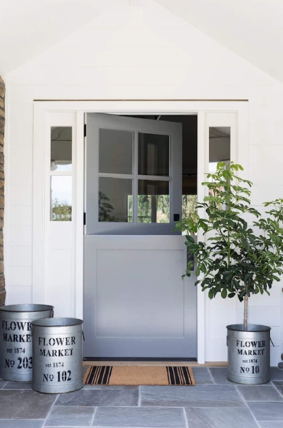 Chantilly Lace paint color on house exterior with Dutch door and farmhouse decor - Studio McGee. #chantillylace #whitepaintcolors #exteriorcolors