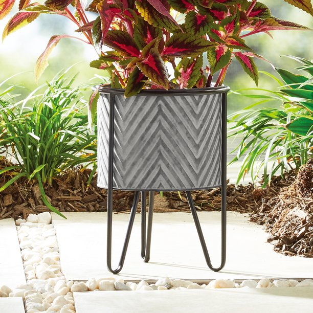 Burnished Galvanized Gray Planter with Stand is designed with an attractive look perfect for complementing a wide variety of indoor and outdoor decor styles. The half-moon tub of this garden planter sits atop a sturdy metal black frame, Crafted of 100% iron, this set of two planters with stands can be used singly or together for your favorite houseplants, flowers, and more.