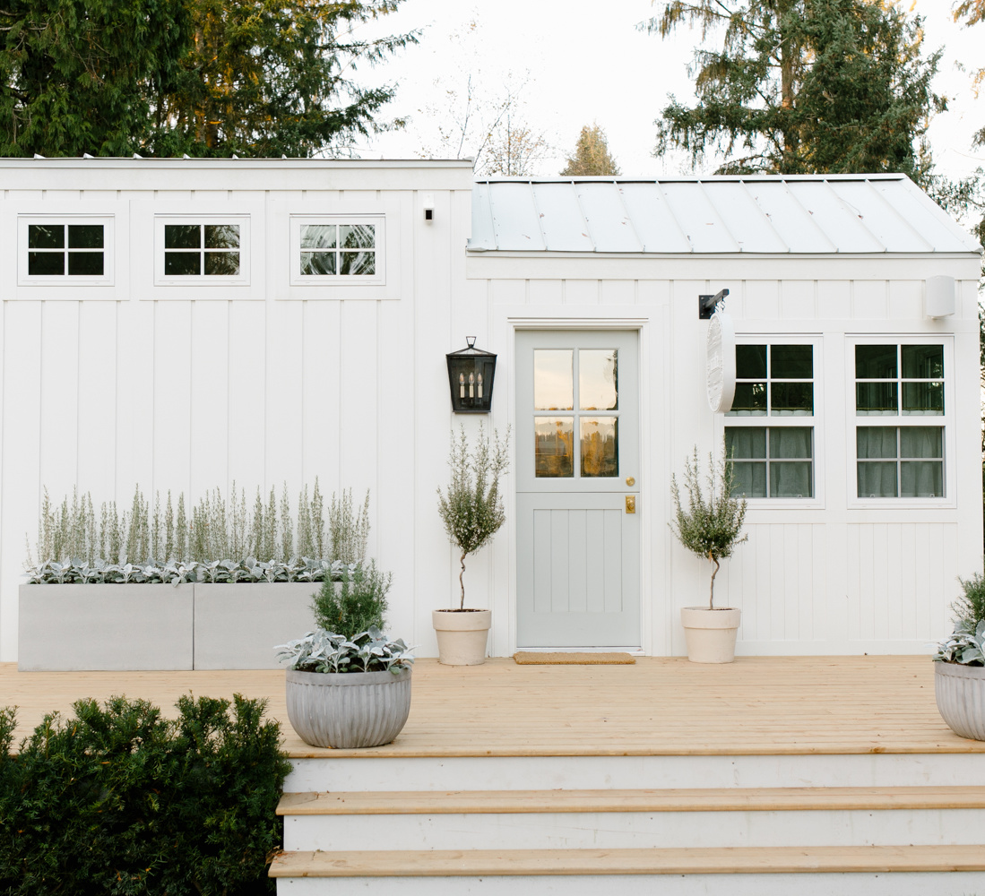 Tiny house exterior painted BM Simply White and trimmed with board and batten - Monika Hibbs. #simplywhite #whitehousecolors #paintcolors