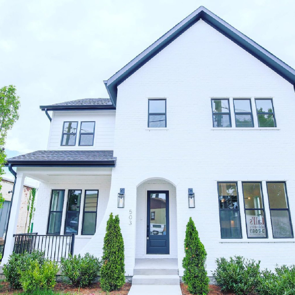 SW Pure White paint color on beautiful brick new house with black trim by 2kdevelopment. #swpurewhite #whitepaintcolors #houseexteriorcolors