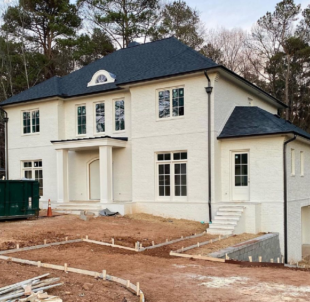 Benjamin Moore White Dove on a brick house exterior - @our_classic_custom_home. #benjaminmoorewhitedove #whitedove #whitedovepaint