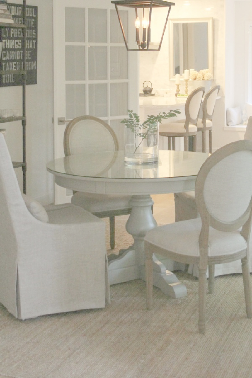 My cozy French country dining room with Louis chairs, round table, and Belgian linen - Hello Lovely Studio.