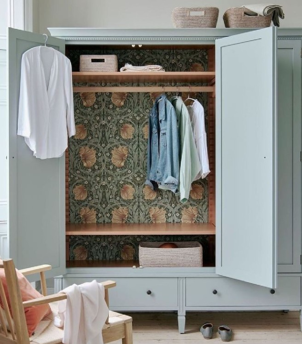 Duck egg blue painted wardrobe with William Morris wallpapered interior - @NeuptuneHomeOfficial. #duckeggblue #wallpaperedinteriors