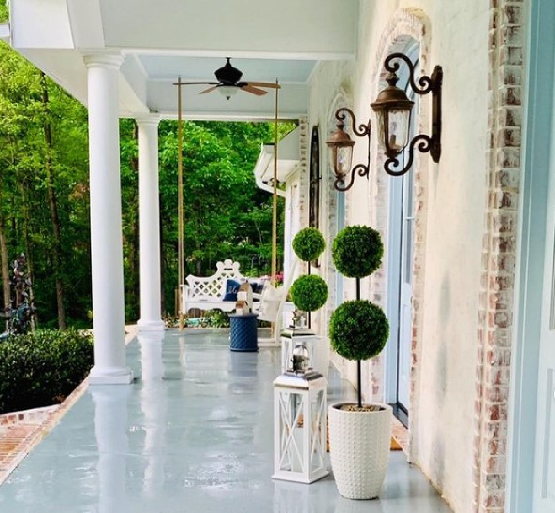 Beautiful light blue porch ceiling, floor, and shutters on a brick home in Mississippi - @forthebayview. #prettyporches