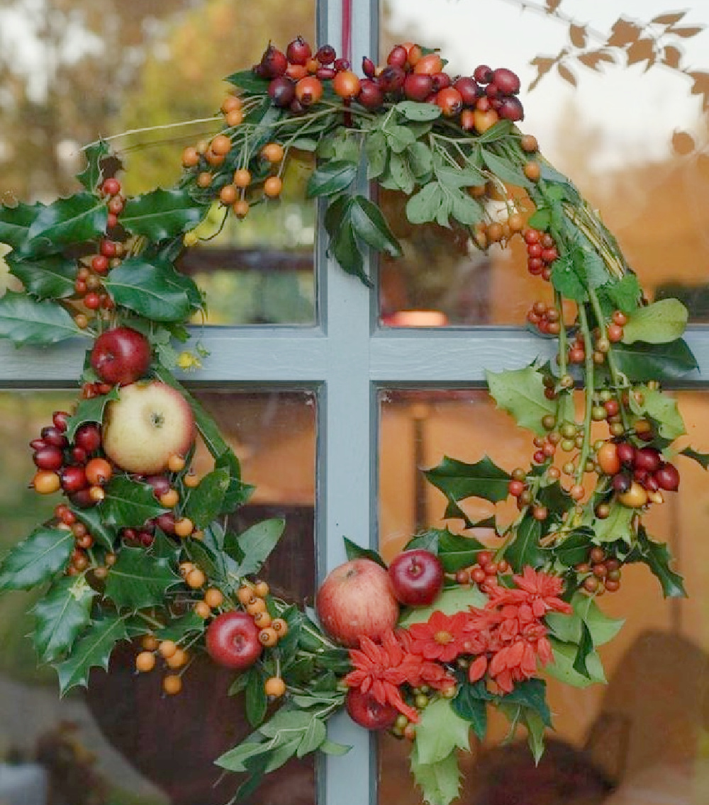 Fruit on a rustic wreath upon a blue French door - Le Moulin Bregeon. #naturalwreaths #frenchcountry