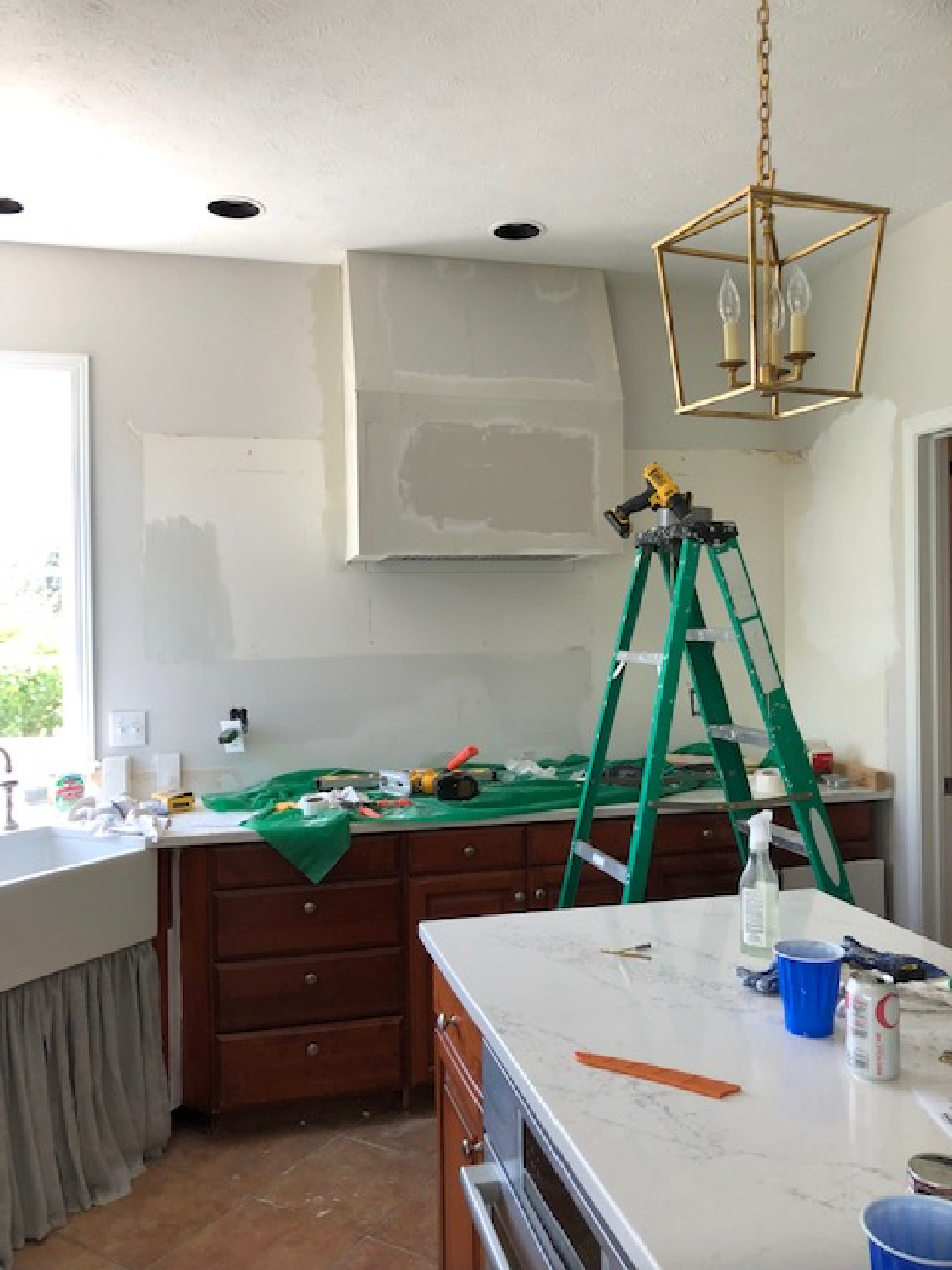 Hello Lovely's kitchen renovation in a traditional Georgian home - custom plaster range hood and farm sink. #hellolovelystudio #kitchenrenovation