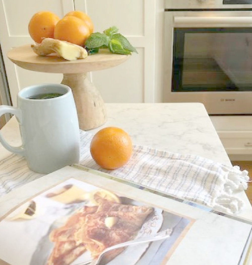 Hello Lovely Studio's white Shaker kitchen with ingredients for mint ginger tea on the counter. #frenchkitchen #frenchfarmhousekitchen