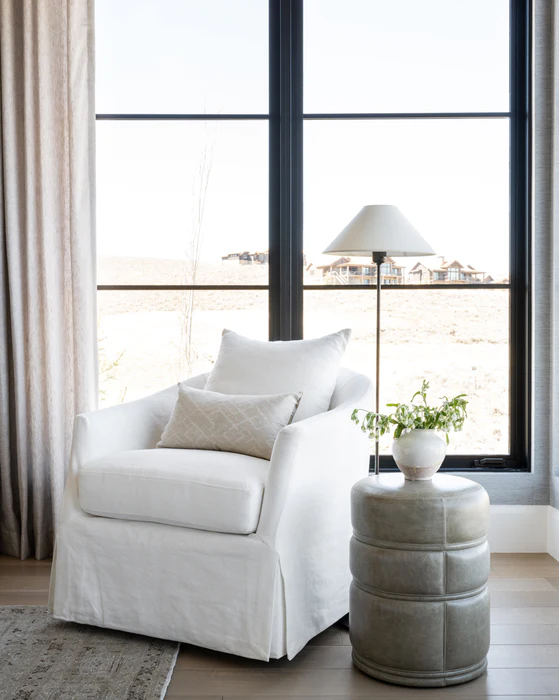 Linen swivel barrel chair (McGee & Co) with a round accent table and floor lamp. #linenvchairs #barrelchair