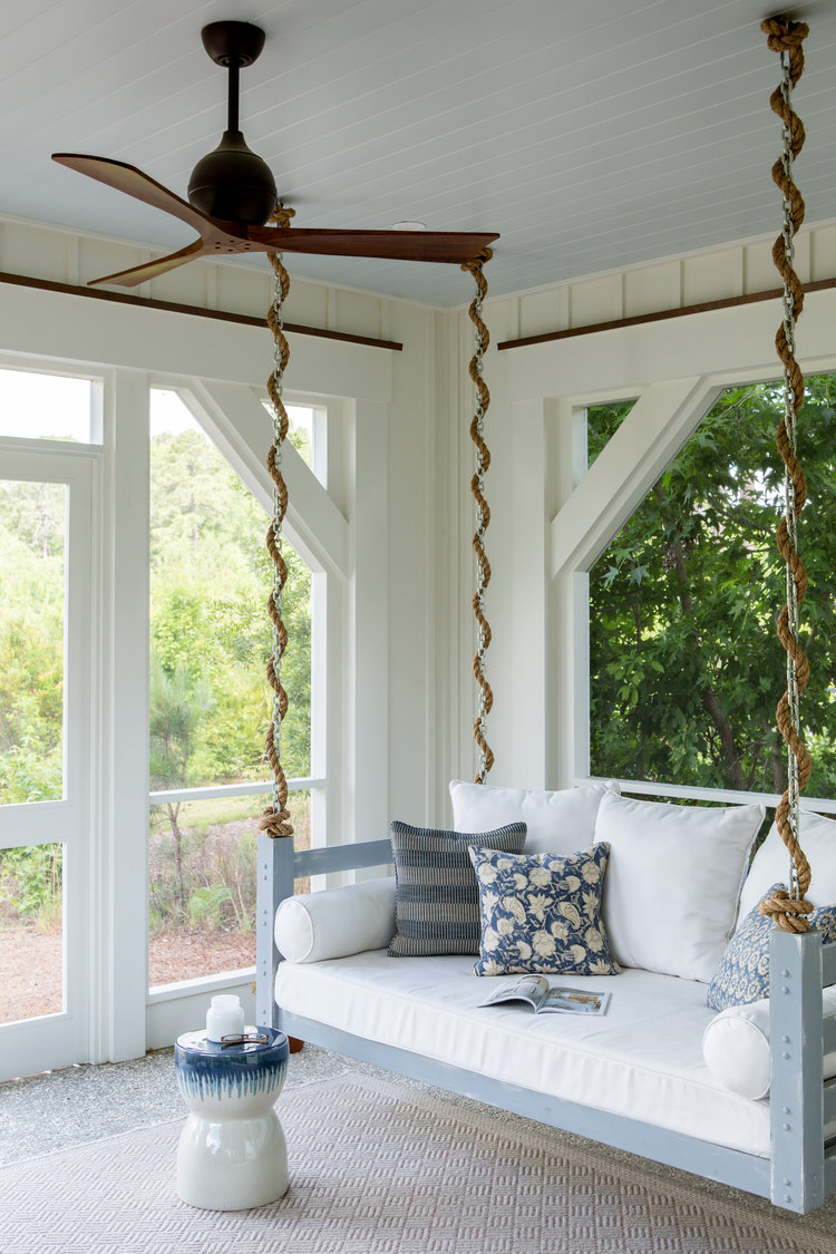 Beautiful coastal porch with hanging bed swing and blue painted ceiling - Lisa Furey. #southernporch #porchswings