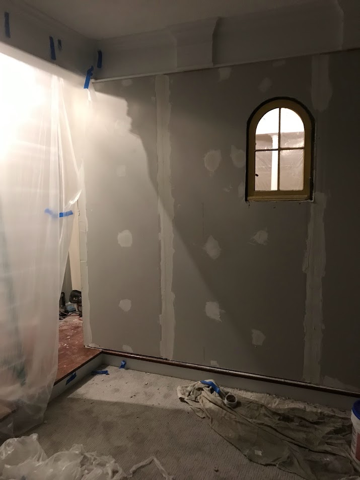 Living room wall and arch window during Georgian renovation