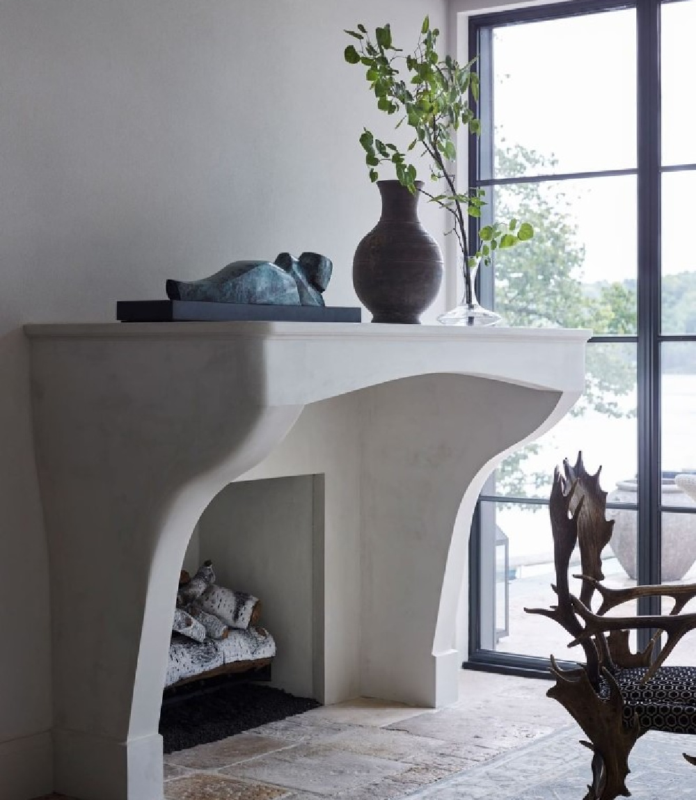 Michael Del Piero designed interior with sculptural fireplace and rustic objects.