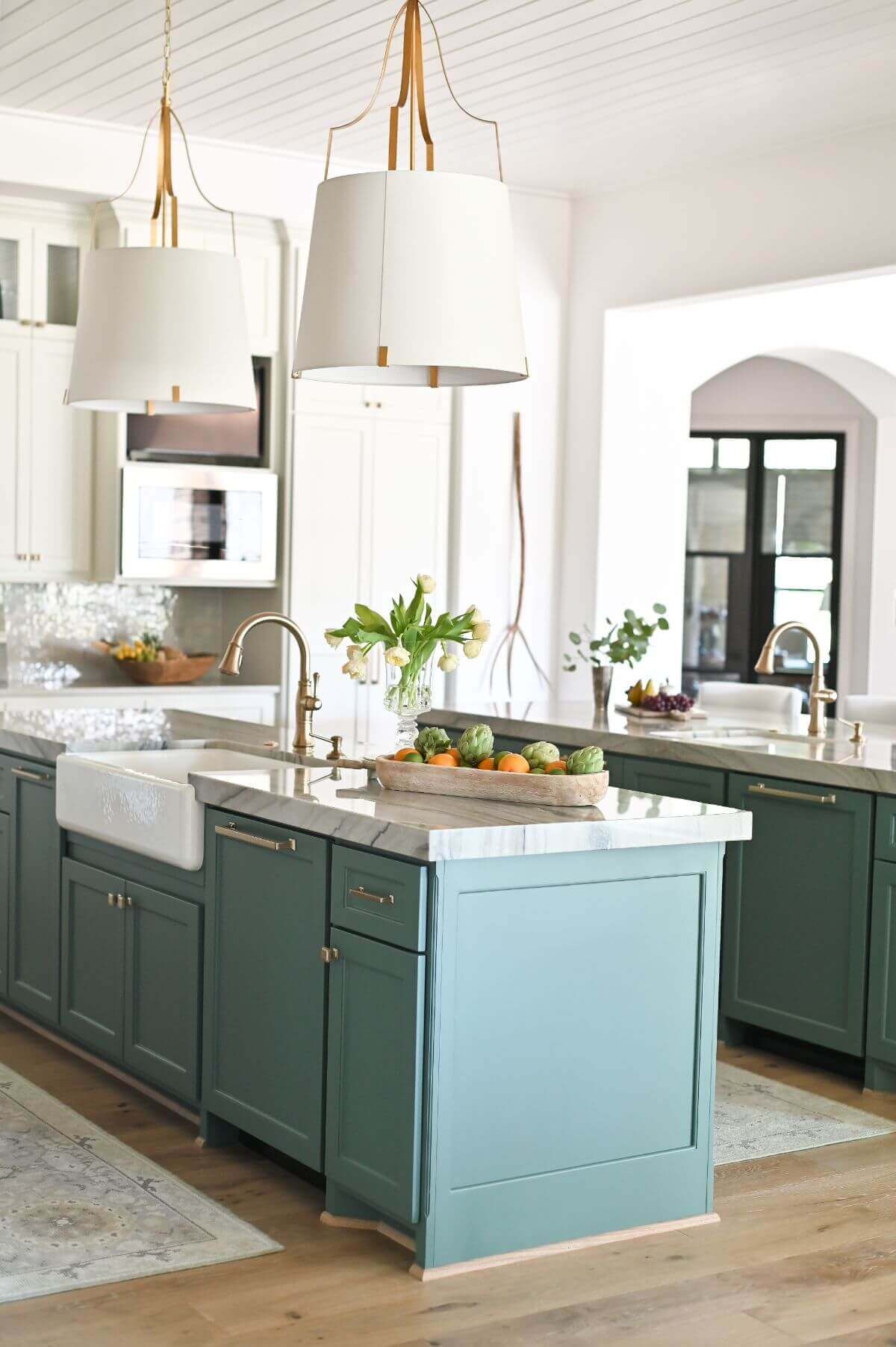Modern French country kitchen with teal painted island, wood range hood, and paneled refrigerator - Morningstar Builders. #modernfrenchkitchen #frenchcountryinteriors