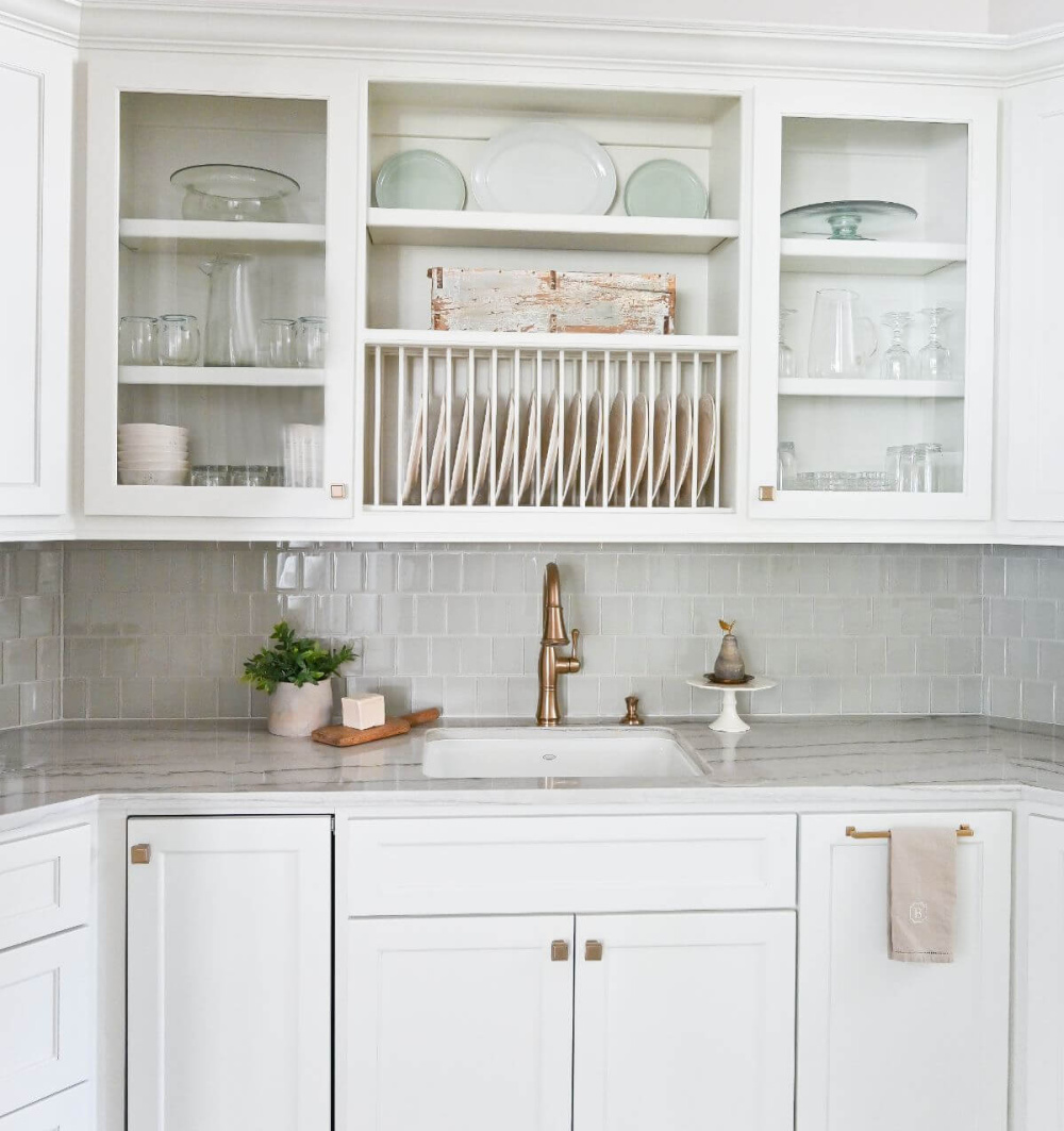 Beautiful white pantry with antiqued barn doors in a French country kitchen - Morningstar Builders. #frenchcountrypantry #frenchkitchen #pantrydesign