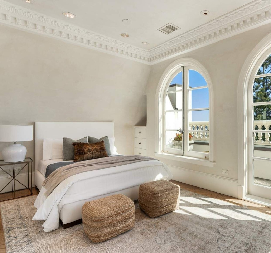 Arched French windows in a bedroom within an elegant French Provincial style home in San Francisco. #frenchbedrooms