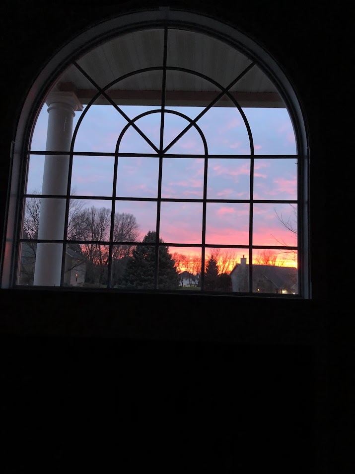Sunset through arched window in foyer during Georgian renovation