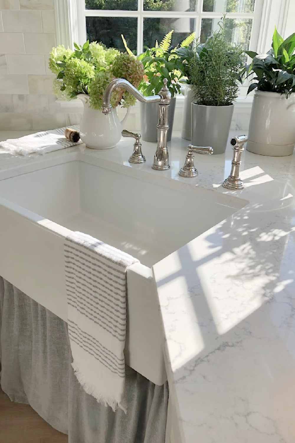 Hello Lovely's farm sink (Hyannis-30 from Nantucket Sinks) in renovated kitchen with Viatera Muse counters and Waterworks Julia faucet. #farmsinks #farmhousesink