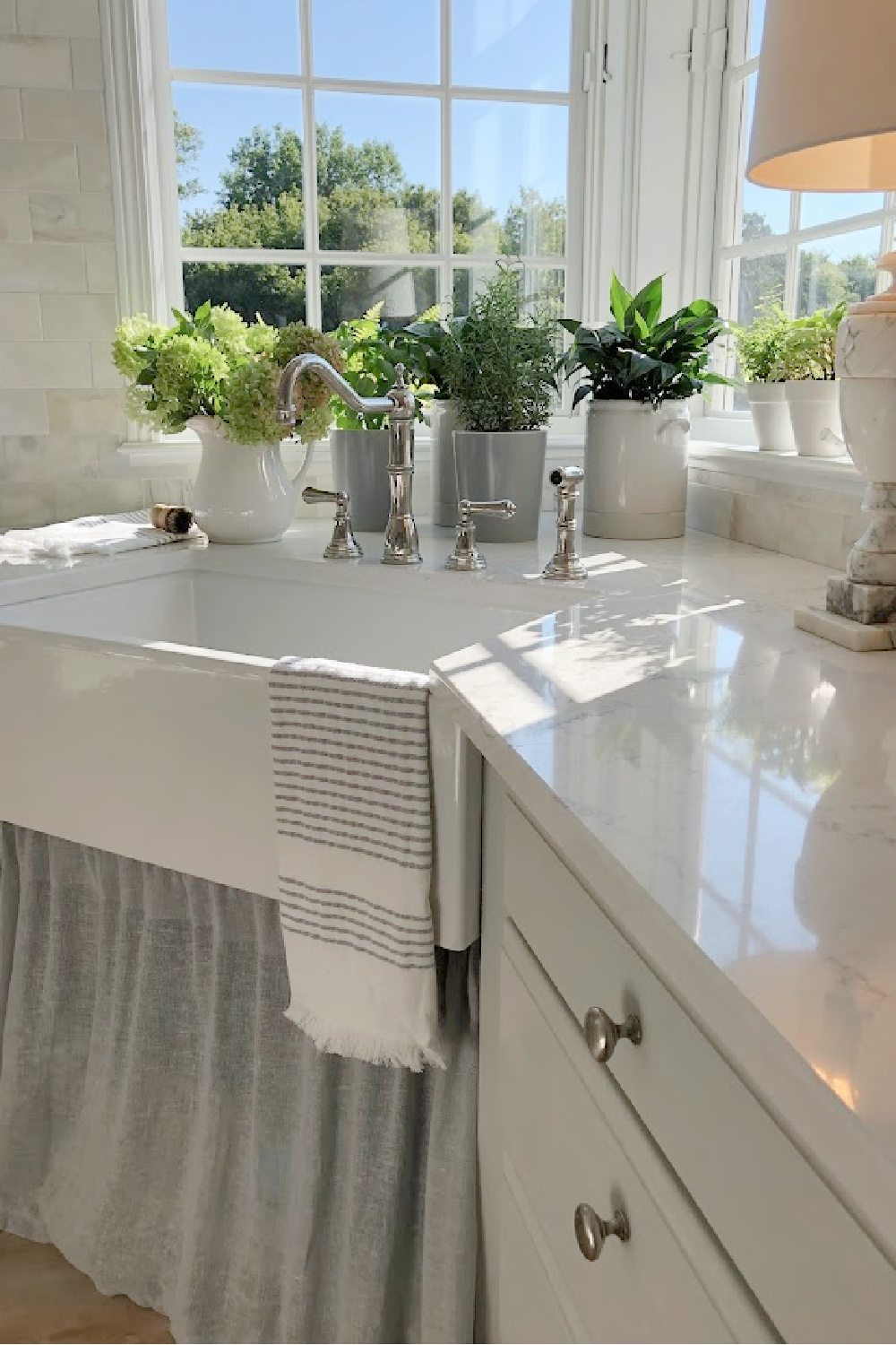 Hello Lovely's farm sink (Hyannis-30 from Nantucket Sinks) in renovated kitchen with Viatera Muse counters and Waterworks Julia faucet. #farmsinks #farmhousesink