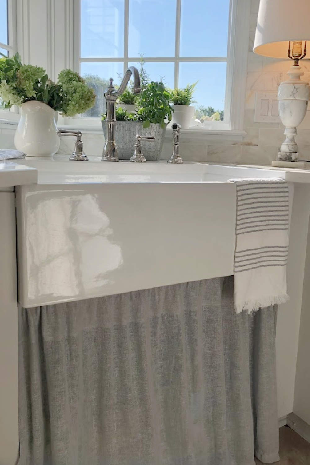 Hello Lovely's farm sink (Hyannis-30 from Nantucket Sinks) in renovated kitchen with Viatera Muse counters and Waterworks Julia faucet. #farmsinks #farmhousesink