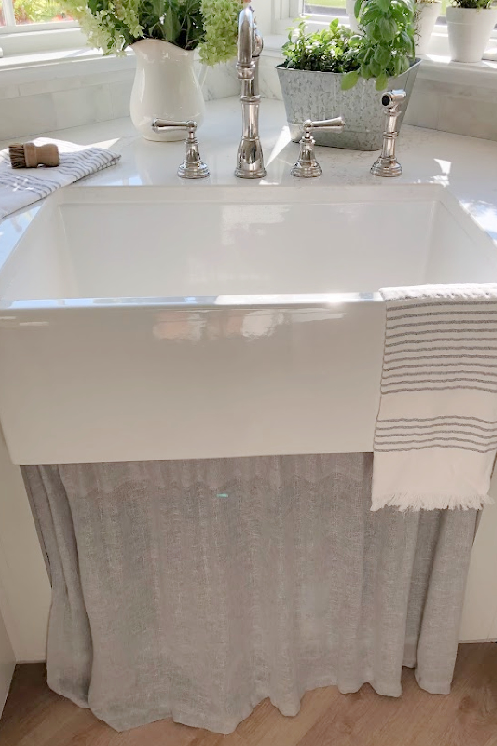 Hello Lovely's farm sink (Hyannis-30 from Nantucket Sinks) in renovated kitchen with Viatera Muse counters and Waterworks Julia faucet. #farmsinks #farmhousesink