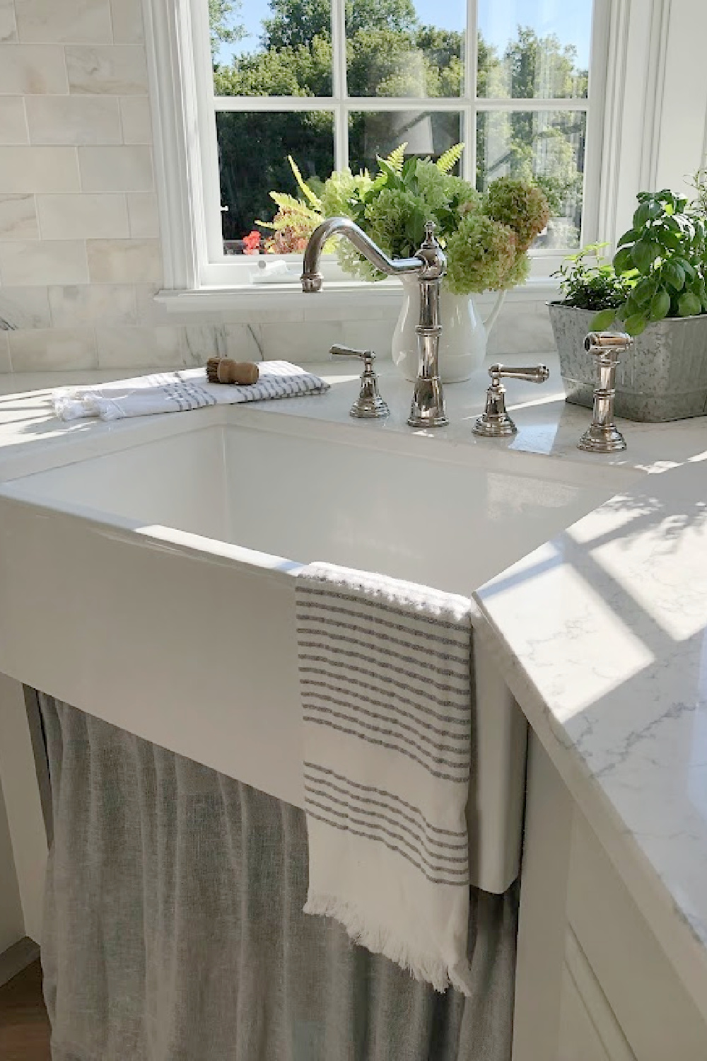 Hello Lovely's farm sink (Hyannis-30 from Nantucket Sinks) in renovated kitchen with Viatera Muse counters and Waterworks Julia faucet. #farmsinks #farmhousesink