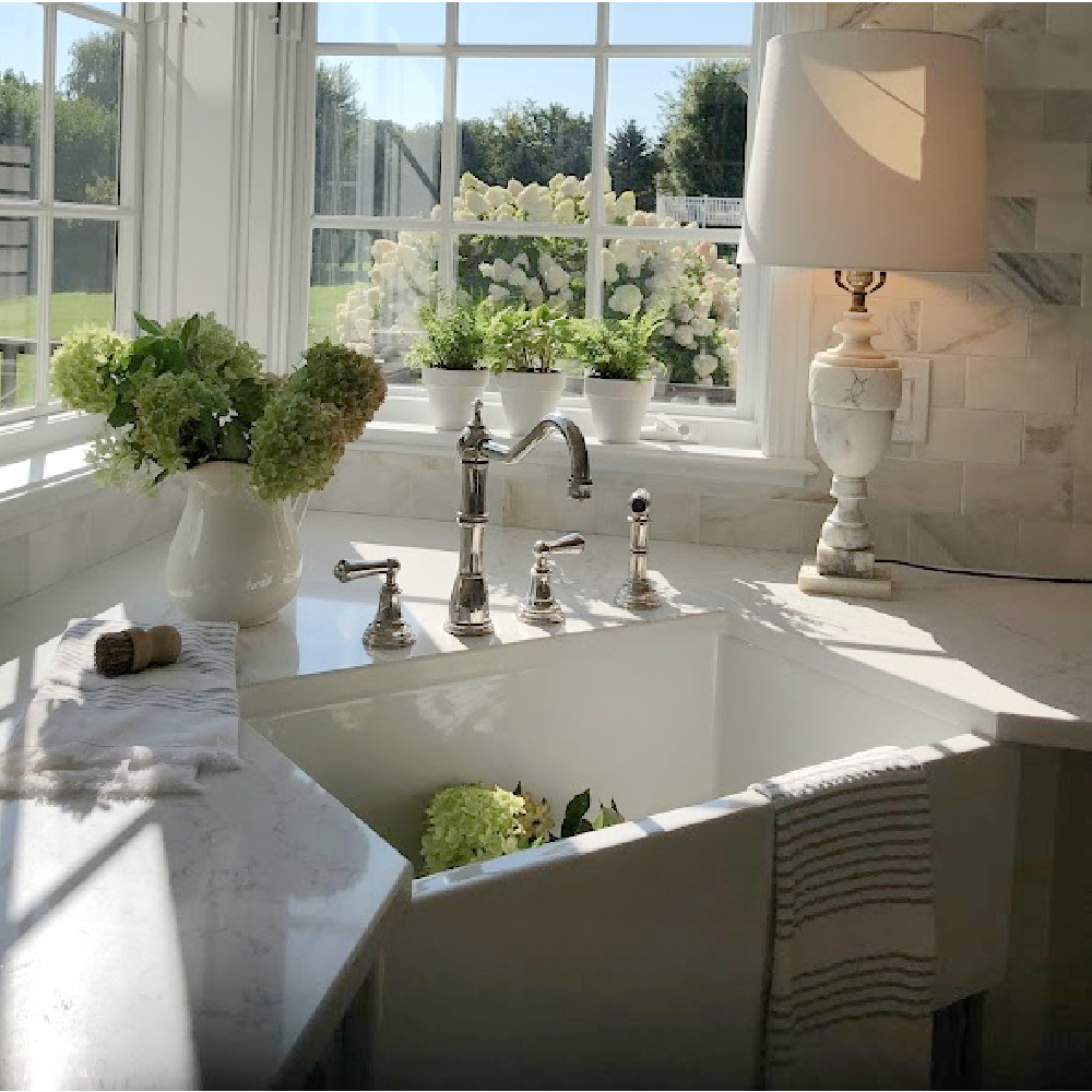 Hello Lovely's farm sink (Hyannis-30 from Nantucket Sinks) in renovated kitchen with Viatera Muse counters and Waterworks Julia faucet. #farmsinks #farmhousesink
