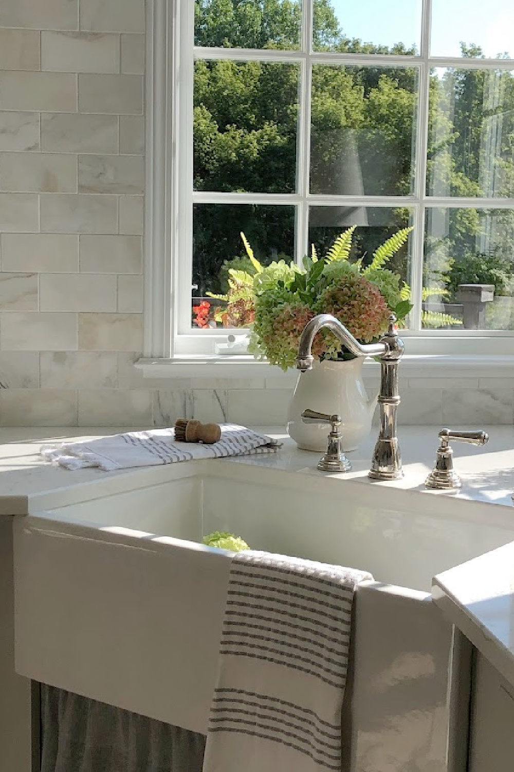 Hello Lovely's farm sink (Hyannis-30 from Nantucket Sinks) in renovated kitchen with Viatera Muse counters and Waterworks Julia faucet. #farmsinks #farmhousesink