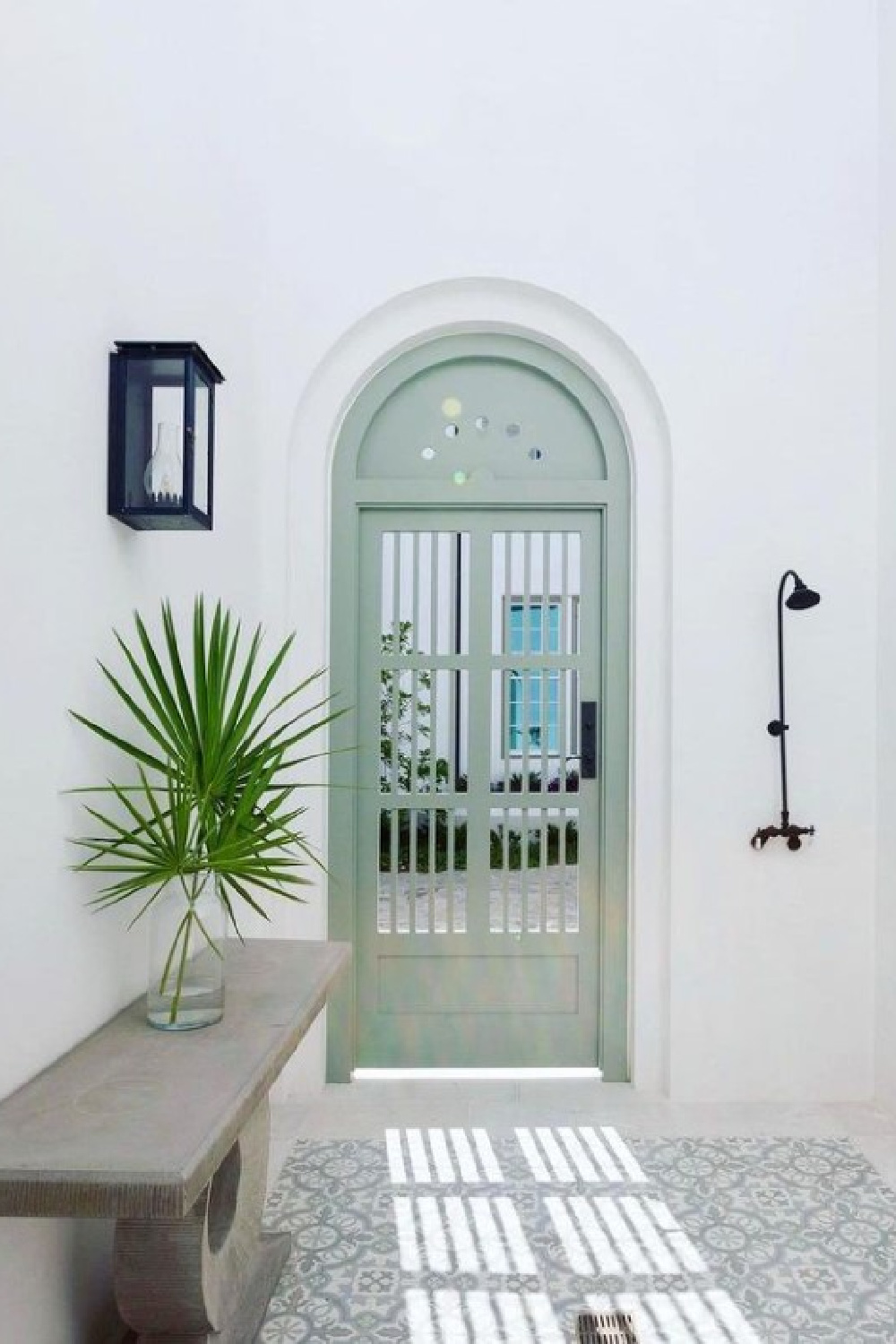 Beautiful arched front door painted Benjamin Moore Flora in an Alys Beach home - @alysbeachconstruction. #benjaminmooreflora #greenpaintcolors